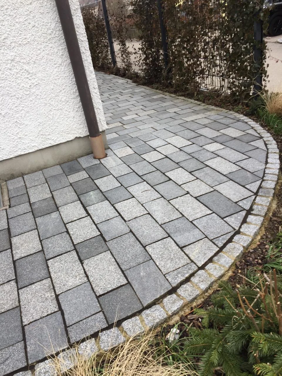 Gepflasterter Weg entlang eines Hauses
